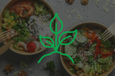two salads in compostable containers with green leaf icon overlay 